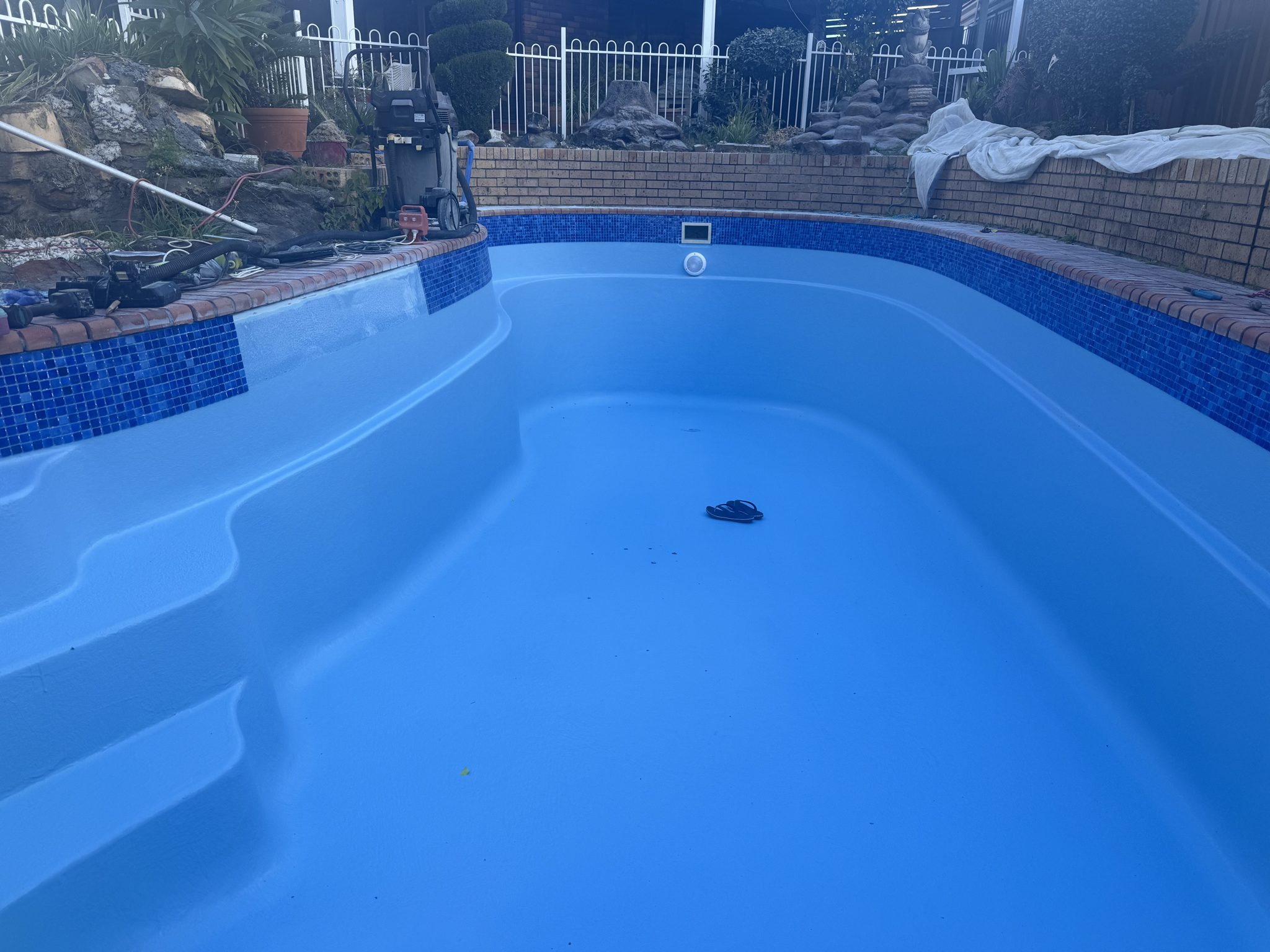 Pool finished in a vivid blue with mosaic waterline