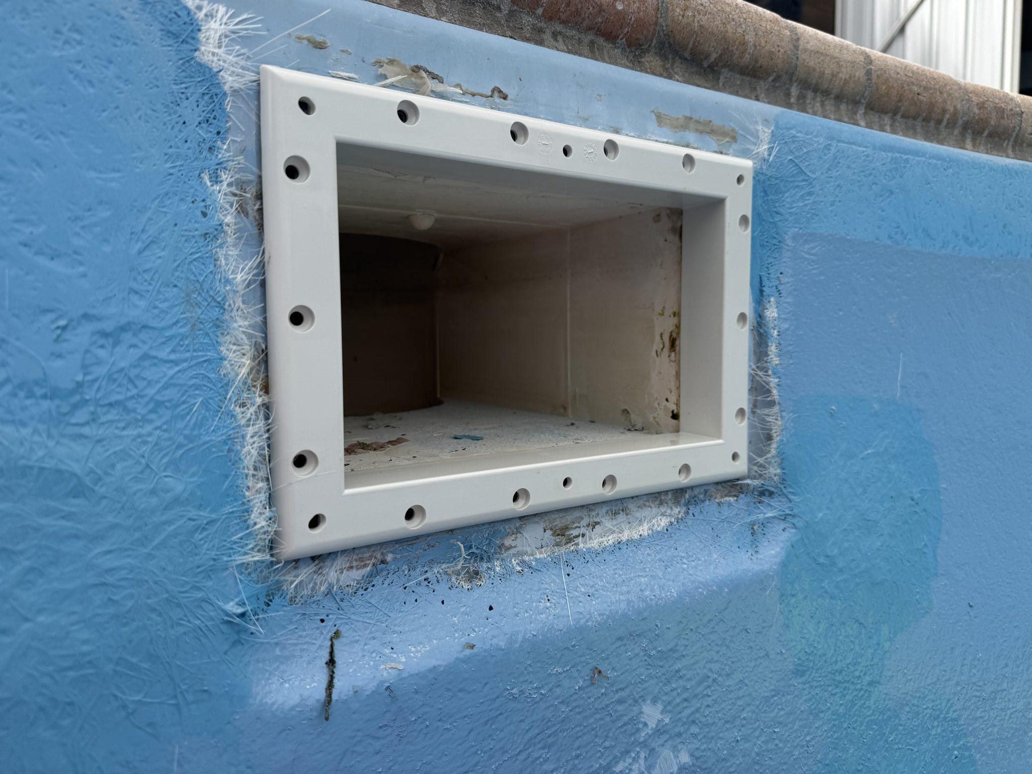 Rebuilt skimmer box set into a freshly coated wall
